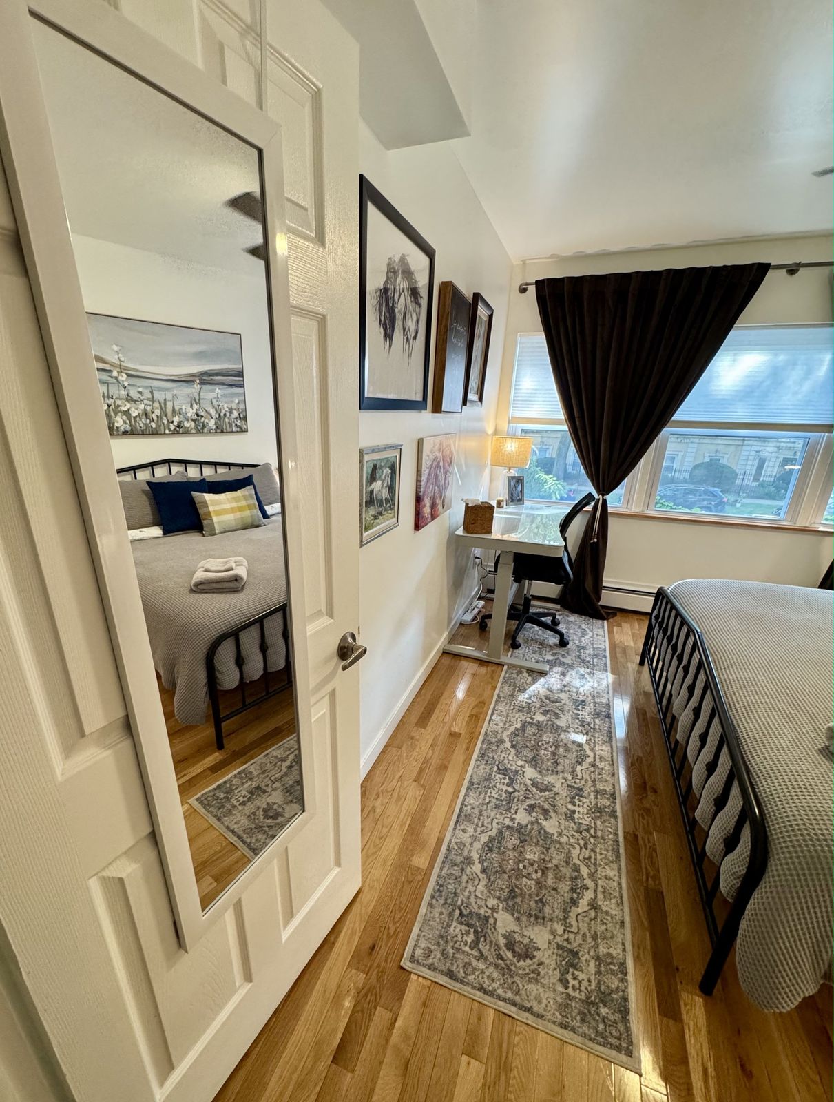 Bedroom doorway with a full length mirror and a long patterned runner